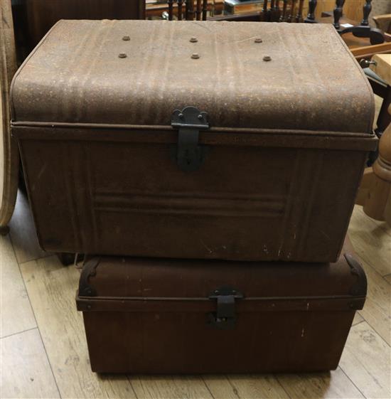 A pair of metal travelling trunks